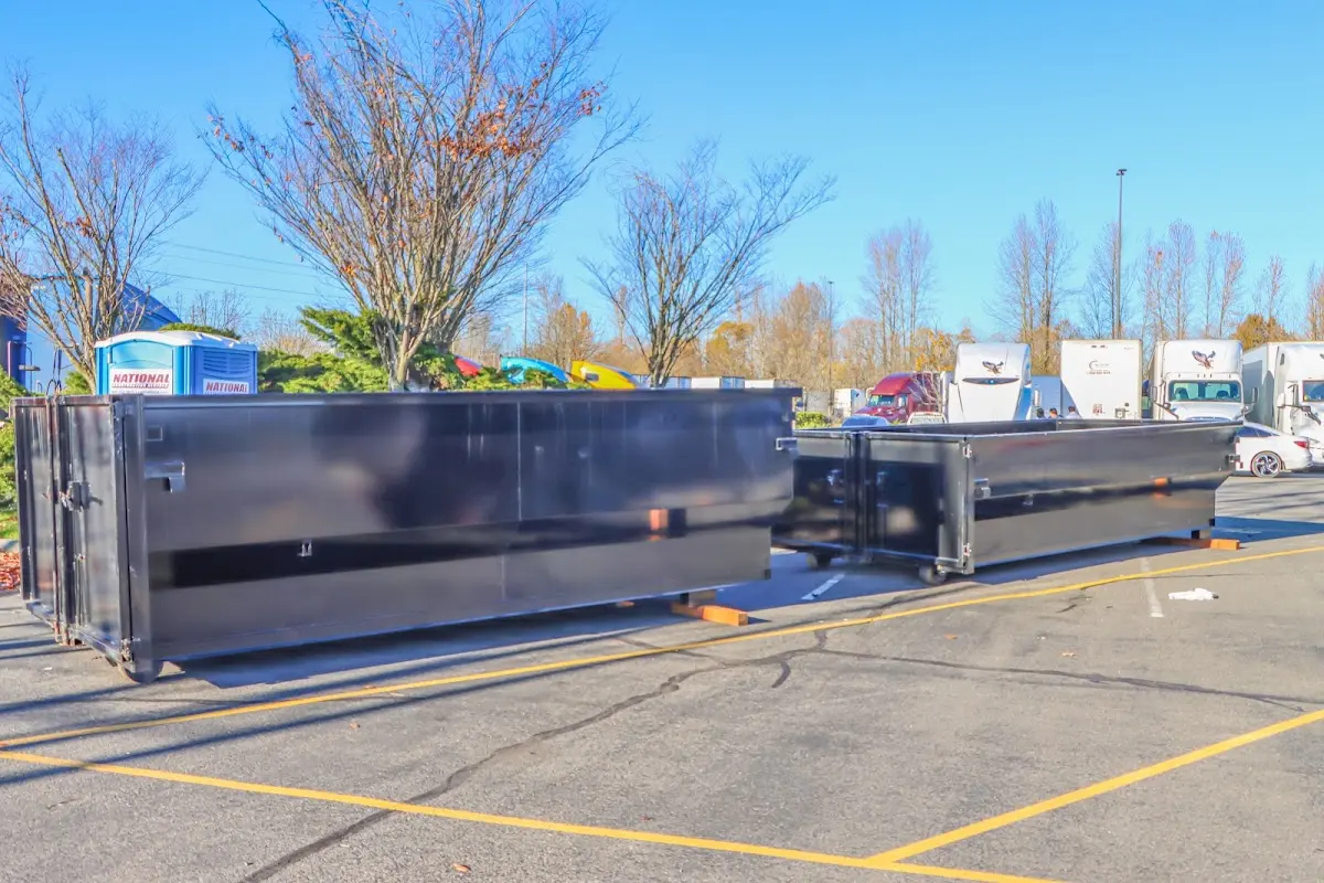 Professional dumpster rental service with roll-off container on residential driveway in Kennesaw